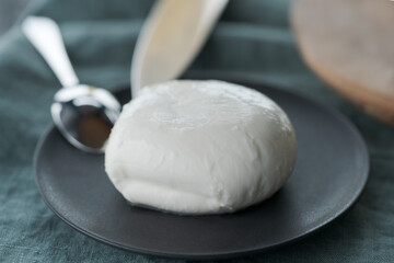 mozzarella ball on small ceramic plate
