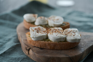 Open sandwich with pesto and mozzarella on linen cloth
