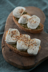 Open sandwich with pesto and mozzarella on linen cloth