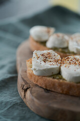Open sandwich with pesto and mozzarella on linen cloth