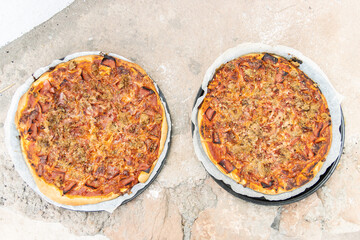 Pizza made in a white painted artisan wood oven built on the outside
