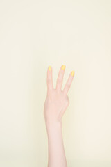 hand showing number three In front of the ivory background