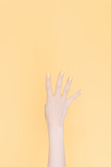 hand showing number four In front of the yellow background,