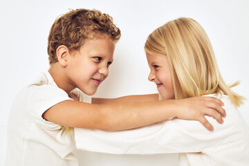 Bad brother sticks to sister smile posing casual wear light background