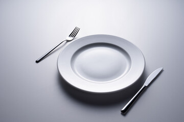 empty plate with fork and knife on white background