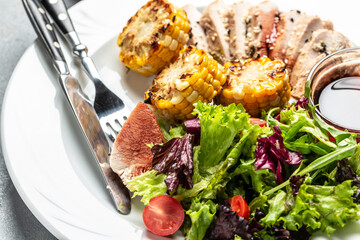 Healthy green salad with chicken breast, grilled corn and sauce, Delicious balanced food concept