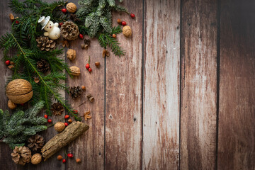 christmas arrangement with snowman nuts and decoration on a rustic, old, wooden background, vintage style