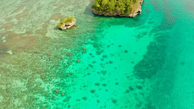 Turquoise lagoon with rocky island and corall reef, aerial view Boracay, Philippines. Summer and travel vacation concept.