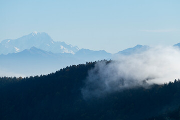 Layers of clouds and forest with mont Blanc in the background