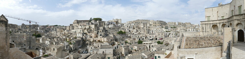 Fototapeta na wymiar Panorama of Matera along a stepped road that goes up the Civita on Sasso Barisano