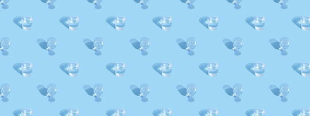 Glasses with water and shadow pattern on blue background banner format