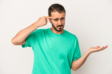 Fototapeta premium Young caucasian man isolated on white background showing a disappointment gesture with forefinger.