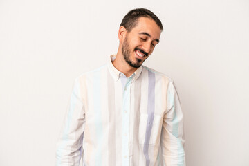 Fototapeta premium Young caucasian man isolated on white background laughs and closes eyes, feels relaxed and happy.