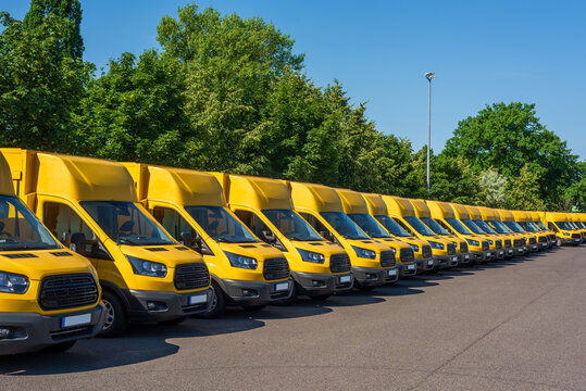 A fleet of electric yellow delivery vans