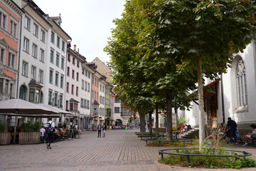 People at the old town of City of Schaffhausen on a cloudy autumn day. Photo taken September 25th, 2021, Schaffhausen, Switzerland.