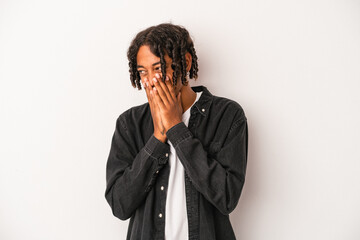 Young african american man isolated on white background laughing about something, covering mouth with hands.