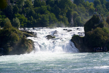 Famous Rhine Falls with rocks and trees on a beautiful autumn day. Photo taken September 25th, 2021, Z&uuml;rich, Switzerland.
