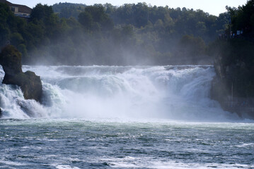 Famous Rhine Falls with rocks and trees on a beautiful autumn day. Photo taken September 25th, 2021, Zürich, Switzerland.