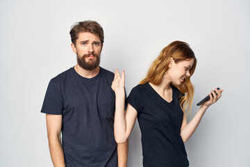 Man and woman with a phone in hand emotions isolated background