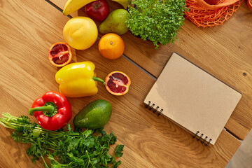 Planning notebook, writing weekly meals on a meal planner note or diet plan