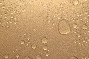Water drop on gold color wall texture background