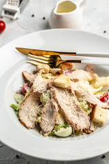 Salad with chicken, delicious chicken caesar salad with parmesan cheese, Food recipe background. Close up