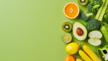 Vegetables and fruits. Sliced avocado, kiwi and broccoli. Lemon, apple and orange. Celery, cabbage and banana. Bell green papper. tomatoes. Concept of healthy diet foodstuffs. Seasonal ingredients.