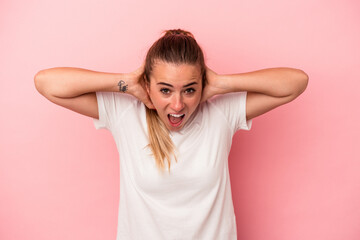 Young Russian woman isolated on pink background screaming, very excited, passionate, satisfied with something.