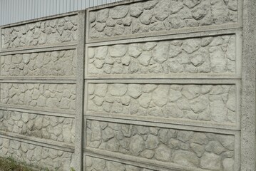part of a large gray concrete fence wall in the street