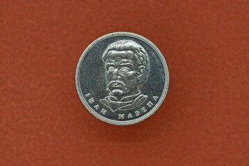 new gray coin of Ukraine ten hryvnia lies on a brown table