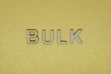 gray word bulk made of wooden letters on brown background
