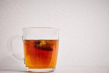 tea in a transparent glass on a white background