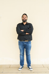 Portrait of handsome bearded Indian man against plain background - 463378903