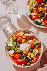 Fresh mediterranean salad with tomatoes and burrata cheese, top view