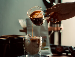 espresso shot dropping in a glass with digital coffee scale