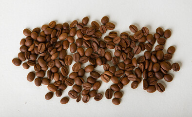 Top view of coffee beans on white surface