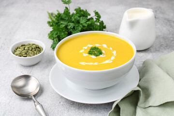 Traditional autumn pumpkin soup with silk texture and pumpkin seeds