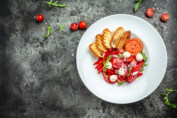 salad with fresh tomato mozzarella, onion and olive oil. Uzbek cuisine banner, menu, recipe place for text, top view