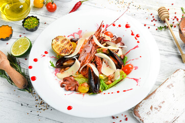 Frutti di mare salad with seafood: shrimp, squid, mussels and octopus. Top view. Rustic style.