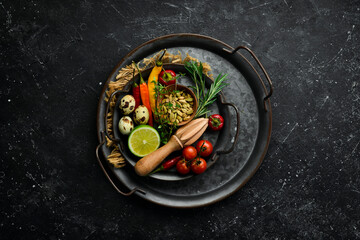 Spices, vegetables and herbs on a metal tray. Food background. Top view. Rustic style.