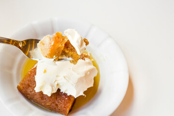 Traditional Turkish Bread Pastry Dessert with clotted cream in syrup.On a piece of fork 