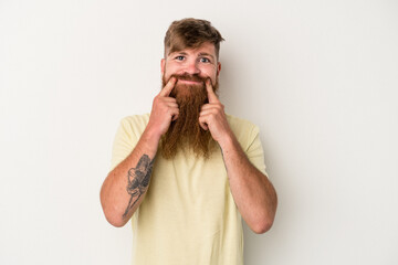 Young caucasian ginger man with long beard isolated on white background doubting between two options.