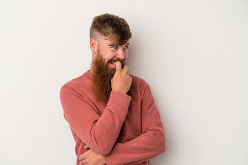 Young caucasian ginger man with long beard isolated on white background relaxed thinking about something looking at a copy space.