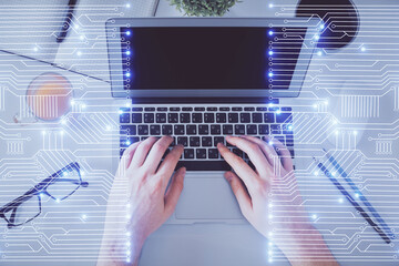 Double exposure of man's hands typing over computer keyboard and tech theme hologram drawing. Top view. Technology concept.
