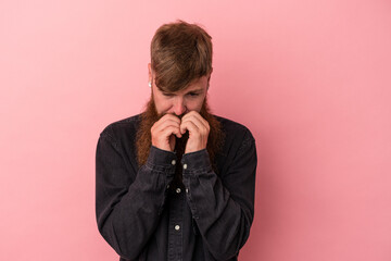 Young caucasian ginger man with long beard isolated on pink background making up plan in mind, setting up an idea.