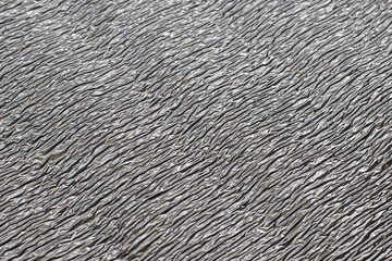 Surface texture of reflective metallic insulation material.