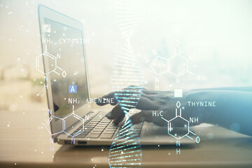 Double exposure of woman hands typing on computer and DNA hologram drawing. Medical education concept.