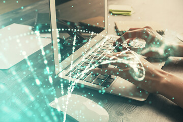 Double exposure of woman hands typing on computer and DNA hologram drawing. Medical education...