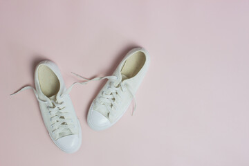 White shoes on a pink background. 