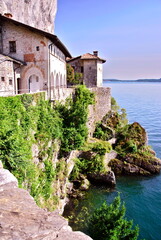 view of the old building on the cliff slope above the sea and mountain view